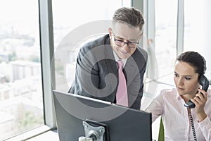 Businessman and businesswoman working together in office