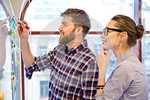 Businessman and businesswoman working with whiteboard