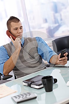 Businessman busy using phone