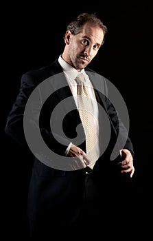 Businessman buttoning jacket, getting dressed.