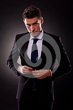Businessman buttoning jacket, getting dressed