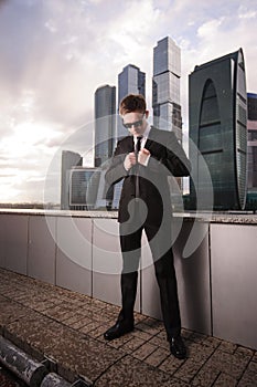 Businessman buttons his jacket on the background