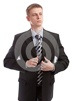 Businessman buttons his suit