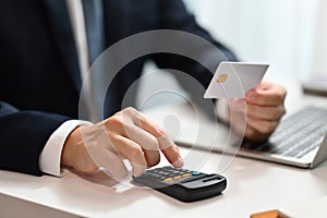 Businessman calculating expenses and debt from credit cards on office desk. E-commerce, financial planning and expenses