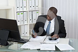 Businessman Calculating Finance Bills