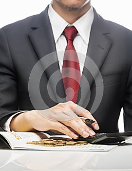 Businessman Calculating Finance With Calculator At Desk over white background