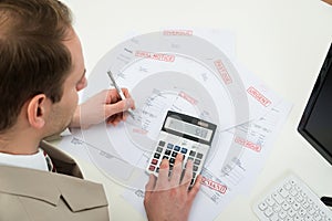 Businessman calculating financial bills photo