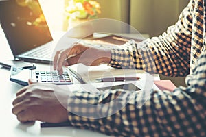 Businessman Calculating Invoice using Calculator In The Office