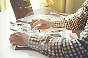 Businessman Calculating Invoice using Calculator In The Office