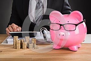 Businessman Calculating Tax On Desk photo