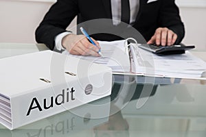 Businessman calculating taxes at desk