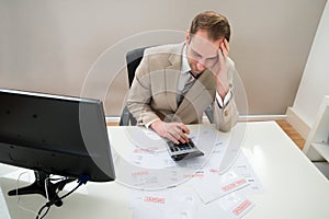 Businessman calculating unpaid bills photo