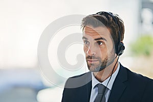 Businessman, call center and consultant with headphones for customer service or telemarketing at office. Man, virtual