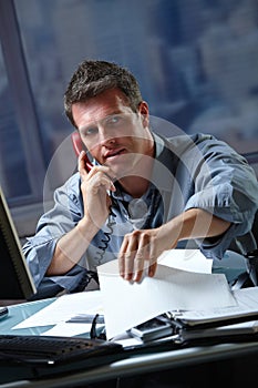 Businessman on call in overtime photo