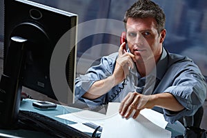 Businessman on call in overtime photo