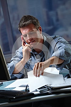 Businessman on call in overtime photo