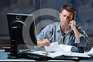 Businessman on call in overtime photo