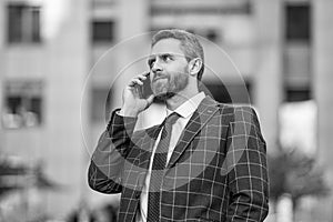 businessman call on phone and talk. businessman has phone call outdoor. businessman having phone call in the street