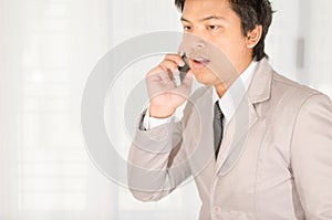 Businessman call a smartphone in office.