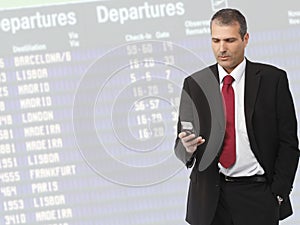 Businessman calling on mobile phone on airport