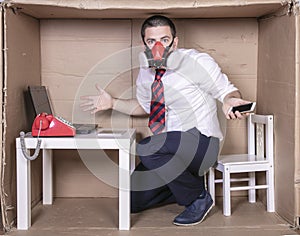 Businessman cannot talk on the phone because he has a mask on his face