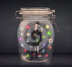 Businessman captured in a glass jar with colourful app icons con