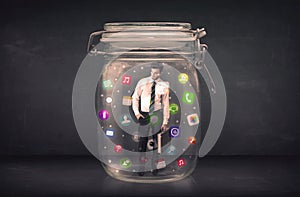 Businessman captured in a glass jar with colourful app icons con