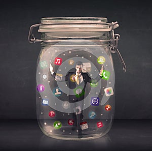 Businessman captured in a glass jar with colourful app icons con