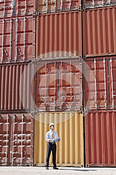 Businessman with cargo containers