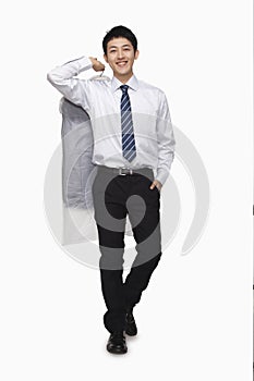 Businessman carrying laundered shirt, studio shot