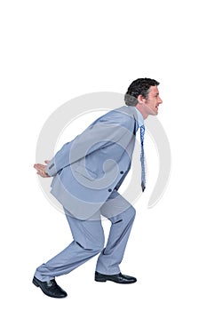 Businessman carrying something with his back and hands