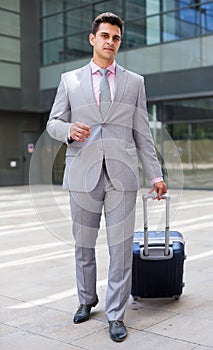 Businessman carrying suitcase