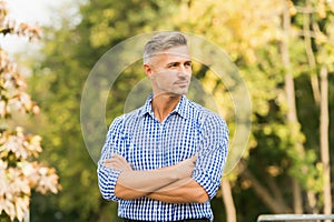 Businessman in casual clothes. Handsome man nature background copy space. Attractive adult man. Rest and relax. Sunny