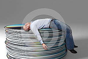 Businessman on cd pile