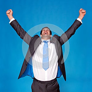 Businessman celebrating with arms raised in the air