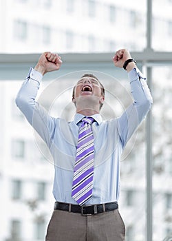 Businessman celebrating with his fists raised in the air