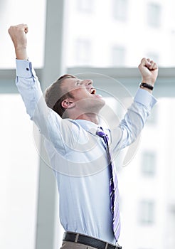 Businessman celebrating with his fists raised in the air