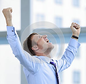 Businessman celebrating with his fists raised in the air