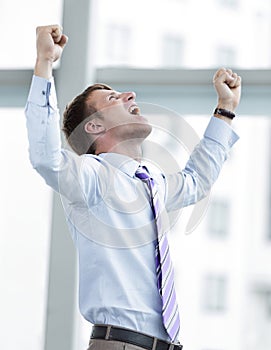 Businessman celebrating with his fists raised in the air