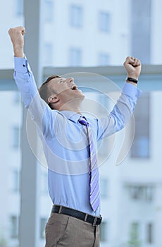 Businessman celebrating with his fists raised in the air