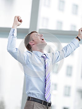 Businessman celebrating with his fists raised in the air