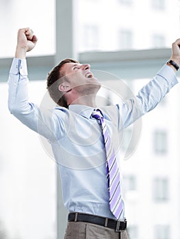 Businessman celebrating with his fists raised in the air