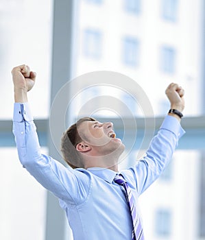 Businessman celebrating with his fists raised in the air