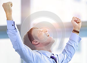 Businessman celebrating with his fists raised in the air