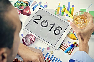 Businessman celebrating the new year in his office