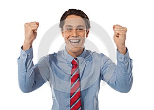 Businessman celebrating success with arms raised