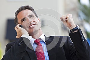 Businessman Celebrating Success On Cell Phone