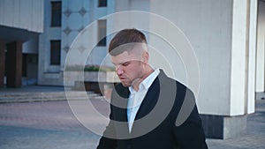 Businessman Celebrating Success while Reading Message in Smartphone near office building. Handsome professional