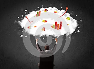 Businessman with charts in a cloud above his head