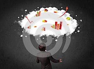 Businessman with charts in a cloud above his head